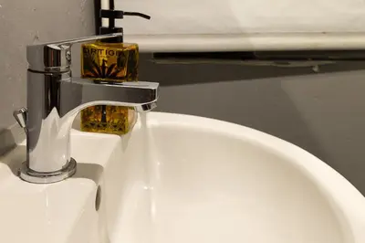 a bathroom sink with a faucet on top of it at Crispi 30 Stylish Apartment in Rome
