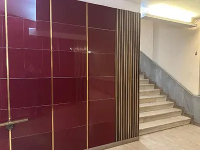 a hallway with a staircase with purple tiles at St.Peter's Moon in Rome