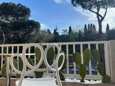 a white fence with a chair and a cactus at St.Peter's Moon in Rome