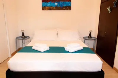 a bedroom with a bed with two towels on it at ArtHouse Termini in Rome