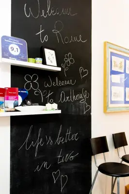 a chalkboard wall with a sign that says welcome to home welcome to authority in at ArtHouse Termini in Rome