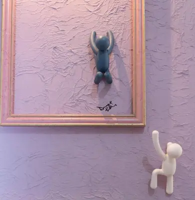 a blue teddy bear on a purple wall with a mirror at ArtHouse Termini in Rome