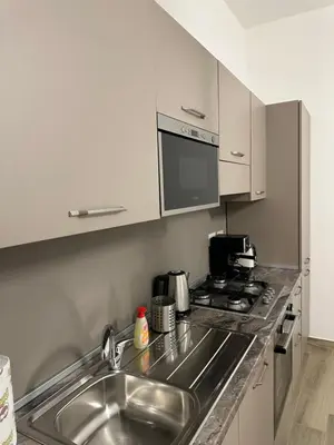 a kitchen with a sink and a stove at Casa Giorgia a 4 fermate metro dal Vaticano in Rome
