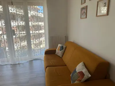 a living room with a brown couch and a window at Casa Giorgia a 4 fermate metro dal Vaticano in Rome
