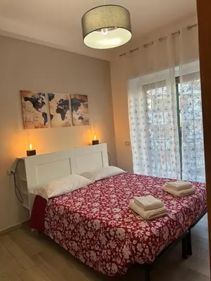 a bedroom with a large bed with two towels on it at Casa Giorgia a 4 fermate metro dal Vaticano in Rome