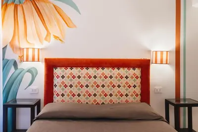 a bedroom with a bed with two side tables at Famo Pace apartments in Rome