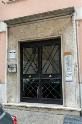 a building with a large glass door at Apartment Colli [3m metro] in Rome