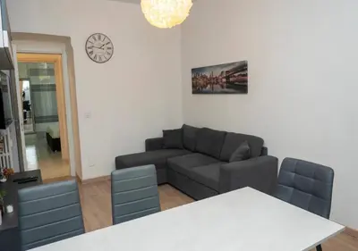 a living room with a couch and a table at Apartment Colli [3m metro] in Rome