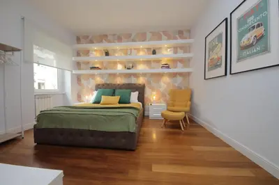 a bedroom with a bed and a chair in a room at YCH-Stylish 3 bedrooms apartment near Vatican in Rome