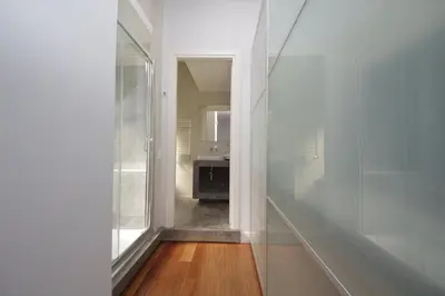 a hallway with a mirror and a sink in a room at YCH-Stylish 3 bedrooms apartment near Vatican in Rome