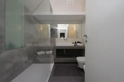 a bathroom with a toilet and a sink and a mirror at YCH-Stylish 3 bedrooms apartment near Vatican in Rome