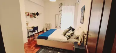 a bedroom with a bed and a desk in it at A casa di chi, Family, Near Metro in Rome