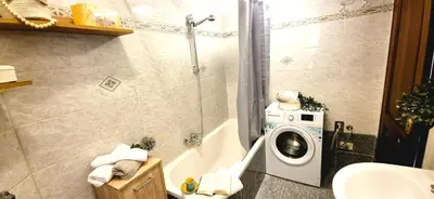 a bathroom with a washing machine in a shower at A casa di chi, Family, Near Metro in Rome