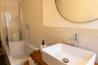 a bathroom with a sink and a mirror and a tub at Giuliana Apartment Vatican in Rome