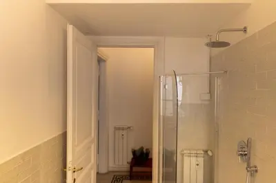a bathroom with a shower with a glass door at Giuliana Apartment Vatican in Rome