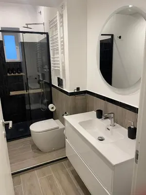 a bathroom with a sink and a toilet and a mirror at Elena's house in Rome