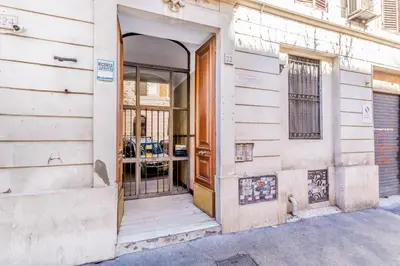 an entrance to a building with a wooden door at Elena's house in Rome