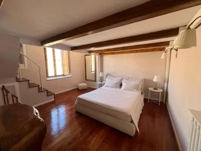 a bedroom with a bed and a stair case at Penthouse 23 - Vatican Charming Apartment in Rome