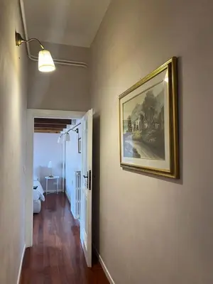 a room with a painting on the wall and a hallway at Penthouse 23 - Vatican Charming Apartment in Rome