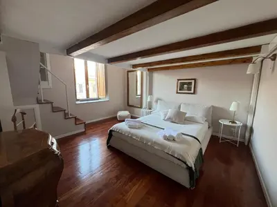 a bedroom with a bed and a staircase in it at Penthouse 23 - Vatican Charming Apartment in Rome