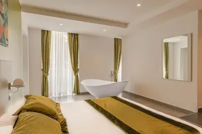 a bathroom with a white tub and a sink at Trevi Palace Hotel in Rome
