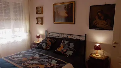 a bedroom with a bed and two lamps and a window at Italian romance - A fine apartment in Rome in Rome