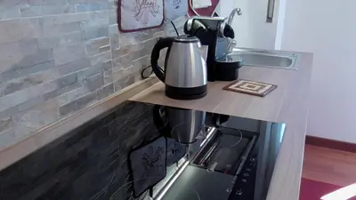 a tea kettle on top of a stove in a kitchen at Italian romance - A fine apartment in Rome in Rome