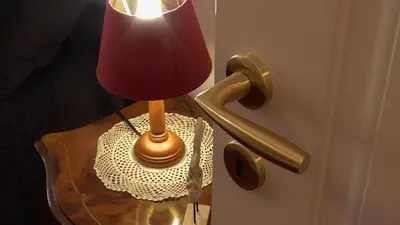 a lamp sitting on top of a table next to a door at Italian romance - A fine apartment in Rome in Rome