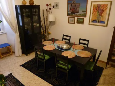 a black table with chairs and plates on it at Apartment Vatican Vista in Rome