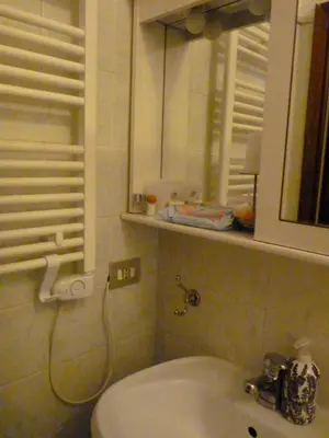 a bathroom with a toilet and a sink and a mirror at Apartment Vatican Vista in Rome