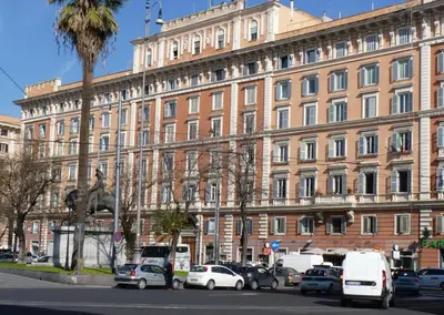 a large building with cars parked in front of it at Apartment Vatican Vista in Rome