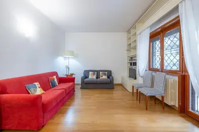 a living room with a red couch and chairs at Vatican home garden by Varental in Rome