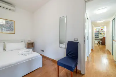 a bedroom with a bed and a blue chair at Vatican home garden by Varental in Rome