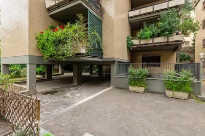 a building with potted plants on the balconies at Vatican home garden by Varental in Rome