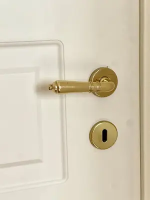 a gold door handle on a white door at Greg Roma in Rome