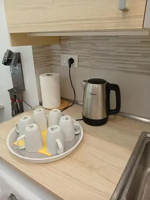 a tray of coffee cups on a kitchen counter at Greg Roma in Rome