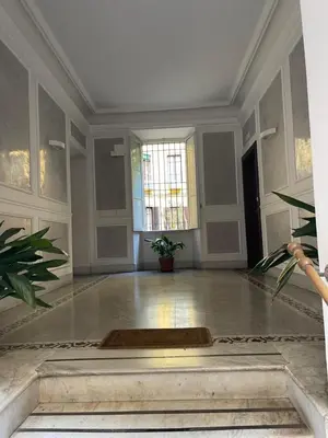 a large white room with a table and a window at Greg Roma in Rome