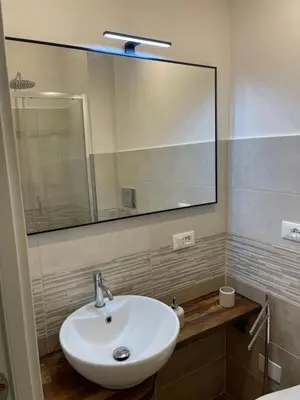a bathroom with a sink and a large mirror at Greg Roma in Rome