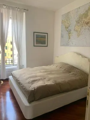 a bed in a bedroom with a map on the wall at Valerio’s House in Rome