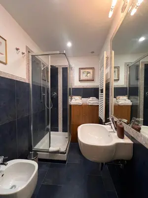 a bathroom with two sinks and a shower at A Casa di Lu, al Colosseo - Guest House in Rome