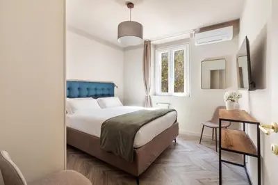 a bedroom with a bed and a window at Vatican Stunning 2 BR Apartment in Rome