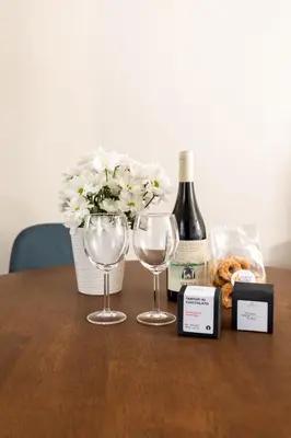 a table with two glasses and a bottle of wine at Vatican Stunning 2 BR Apartment in Rome