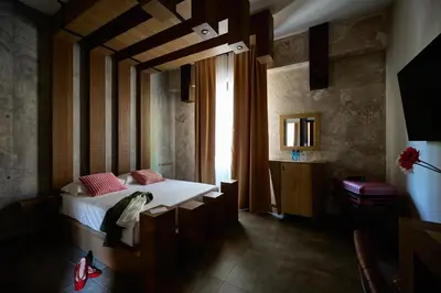 a bedroom with a bed and a large window at Mamaco Roma in Rome
