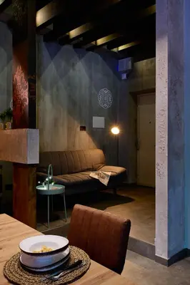 a living room with a couch and a table at Mamaco Roma in Rome