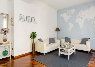 a living room with two couches and a world map on the wall at Romely House St Peter Apartment in Rome