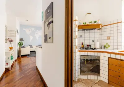 a kitchen with a white refrigerator in a room at Romely House St Peter Apartment in Rome