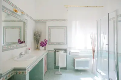 a bathroom with a sink and a shower and a tub at Romely House St Peter Apartment in Rome
