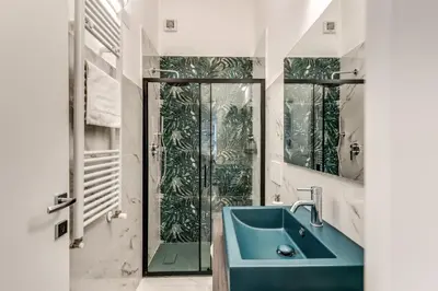 a bathroom with a blue sink and a shower at NALA & KIRA - Two big apartments for groups in the center of Rome in Rome