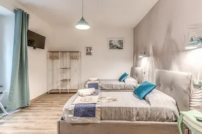 a living room with two beds and a couch at NALA & KIRA - Two big apartments for groups in the center of Rome in Rome
