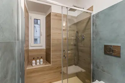 a shower with a glass door in a bathroom at NALA & KIRA - Two big apartments for groups in the center of Rome in Rome